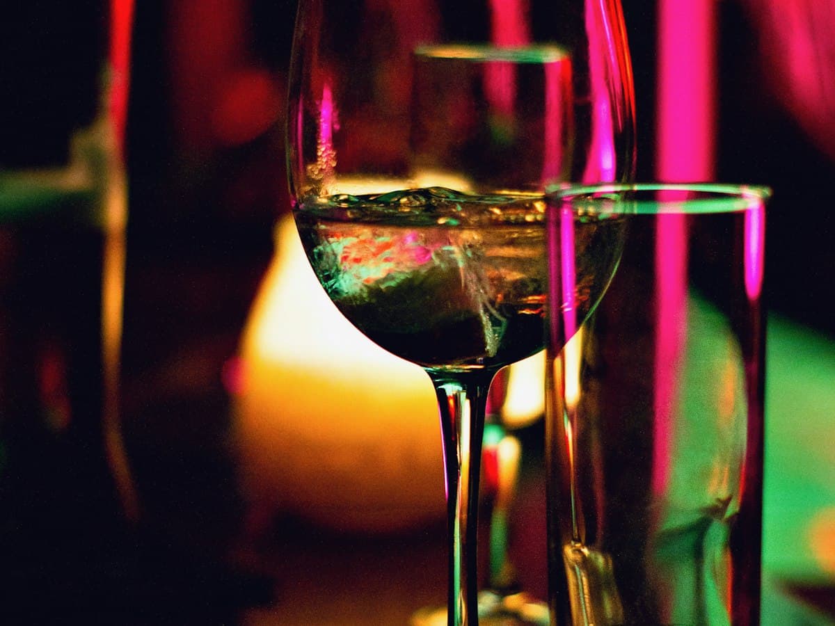 Wine glasses lit by warm bar lighting
